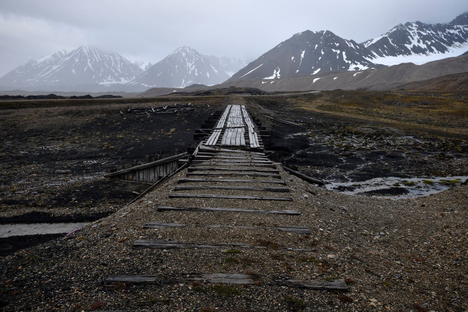 Ny-Ålesund, Svalbard Islands, Norway, July 2018. Remains of the former coal mine that was closed in 1962 after a firedamp explosion killed 21 miners. It was replaced in 1966 with an international research center on the Arctic and the environment. The village, with a population of 30 to 150, has an airport, a post office, a gift shop and a history museum.